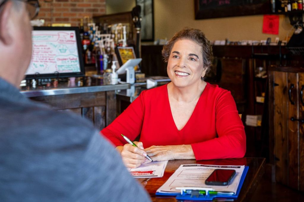 Nancy at a table in a consultation