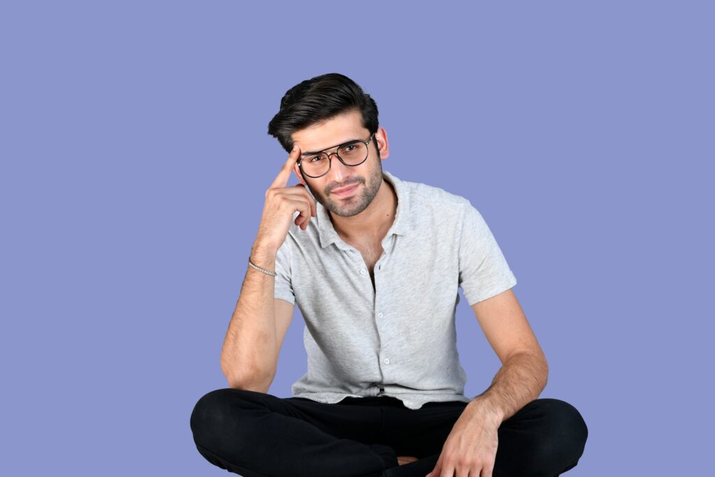 a man sitting on the floor looking confused